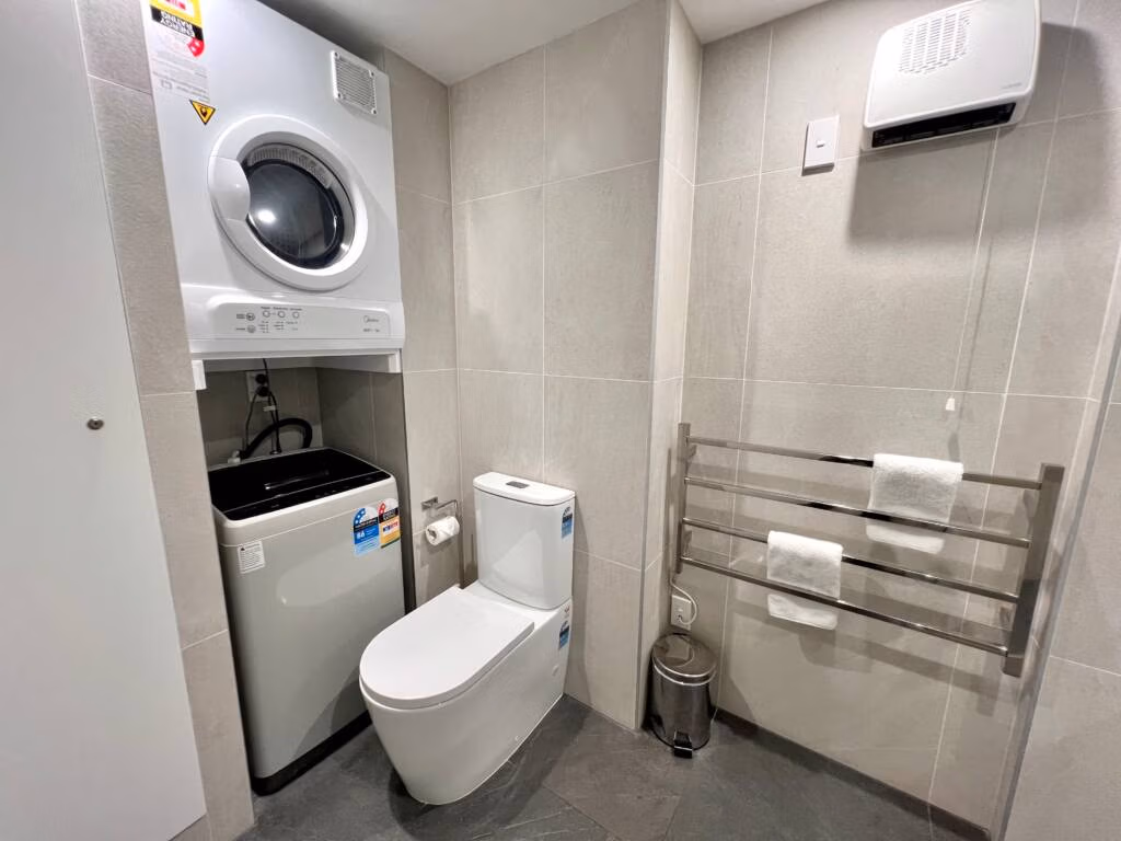 Twin Studio Apartment bathroom with laundry